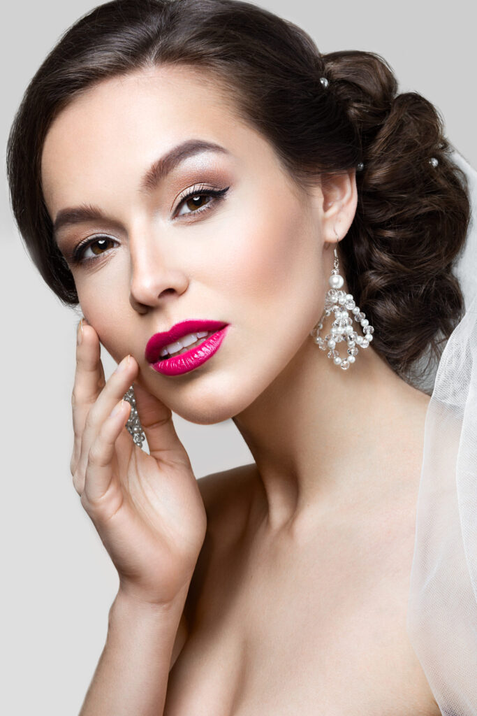Braut mit elegantem Make-up, Winged Eyeliner und pinkem Lippenstift